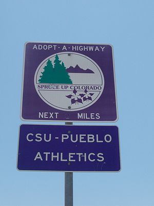 Square, purple Adopt-a-Highway sign in Colorado with a rectangular sign below it that says "CSU - PUEBLO ATHLETICS"