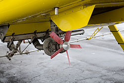 Detail of the sprayer system attached to an Air tractor AT-502B aircraft. Image shows the sprayer system's air-driven pump.