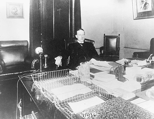 Smith at his desk in the New York Assembly in 1913