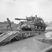 An Achilles 17pdr Self-propelled anti-tank gun crossing the River Savio on a Churchill ARK which was driven into the river, 24 October 1944