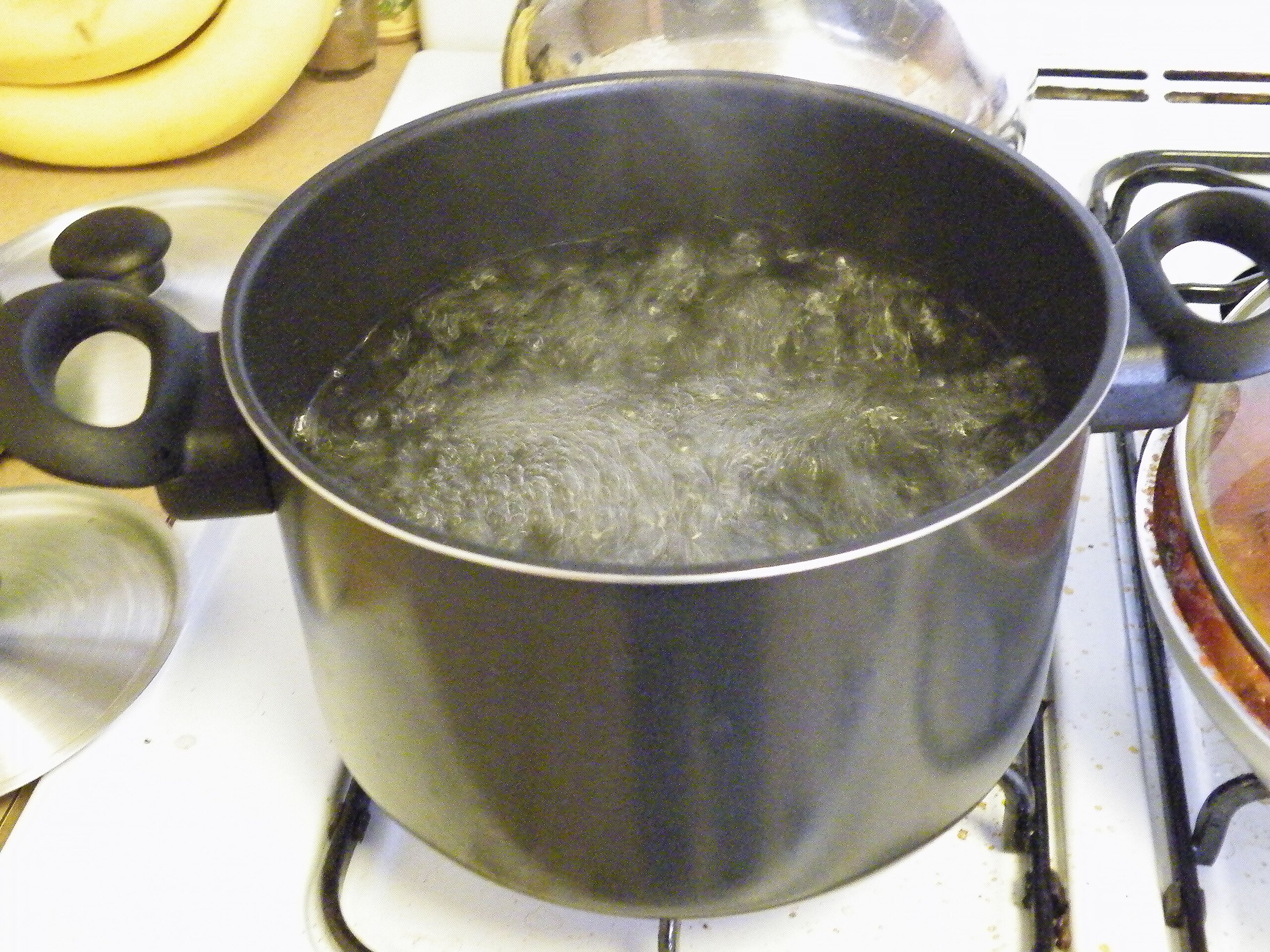 Boiling Pot of Water on Stove With Copy Space Stock Photo by