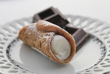 Cannoli are Sicilian pastry desserts, consisting of tube-shaped shells of fried pastry dough, filled with a sweet, creamy filling usually containing ricotta.
