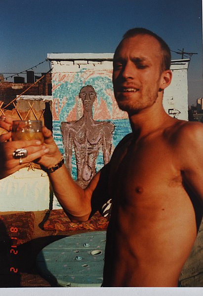 File:Craig Coleman with Mural on roof at 44 East First Street .jpg