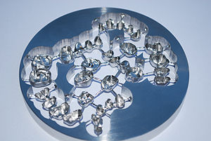 Chrome-cobalt disc with bridges and crowns manufactured using WorkNC Dental CAD/CAM Disc with dental implants made with WorkNC.jpg