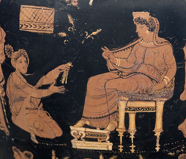 Demeter, enthroned and extending her hand in a benediction toward the kneeling Metaneira, who offers the triune wheat (c. 340 BC)