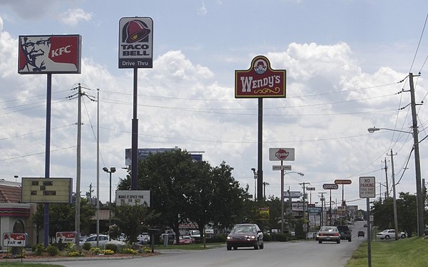 Neighboring fast food restaurant advertisement signs in Bowling Green, Kentucky for Wendy's, KFC, Krystal and Taco Bell. A McDonald's sign can be seen