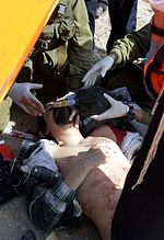 Viflic being resuscitated by paramedics Fatally wounded Israeli school boy.jpg