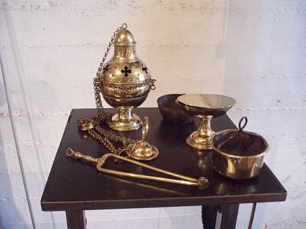 Clockwise from upper left: Thurible, cup from inside thurible, incense boat, charcoal holder, and tongs (museum De Crypte, Gennep, Netherlands)