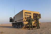 Italian Army - 5th Field Artillery Regiment "Superga" M270 MLRS reloading during exercise NASR 2021 in Al Qalail (Qatar).jpg