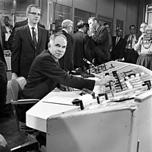 AEC Chairman Seaborg at the MSRE controls in 1968 for startup with U-233. MSRE U-233 Seaborg (14480987473).jpg