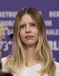 Mia Goth (pictured) plays both Pearl and Maxine in X. The dual casting was employed by director Ti West to emphasize the similarities between the characters. Mia Goth at Berlinale 2023 -1 (cropped).jpg