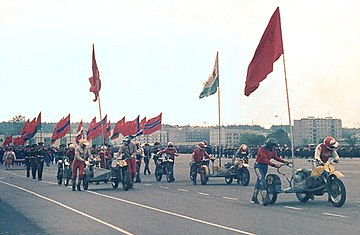 The State Flag of the USSR (pictured in the foreground) leading the parade with flags of all 15 Soviet republics following from behind during a Victory Day parade in 1984