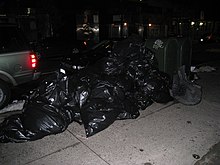 A pile of trash bags placed curbside for collection Monday must be garbage day (2116462531).jpg