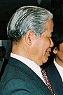 An old graying man wearing suit and tie