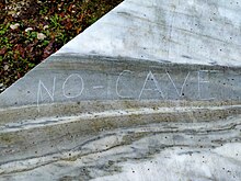 No Cav slogan on a marble block close to the Henraux quarry gate in Azzano (Seravezza) No Cav slogan in Azzano (Seravezza).jpg