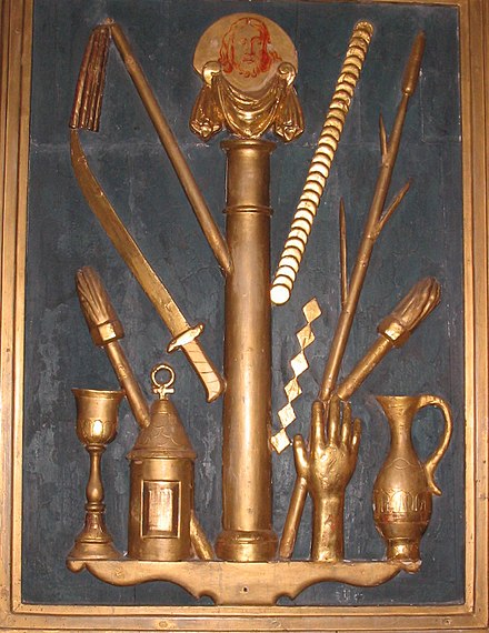 The instruments of the Passion (cont). Left to right: chalice, torch, lantern, sword, flagellum, pillar of flagellation, Veronica's veil, 30 pieces of silver, dice(?), reed sceptre, hand which struck Christ, torch, pitcher of gall and vinegar.