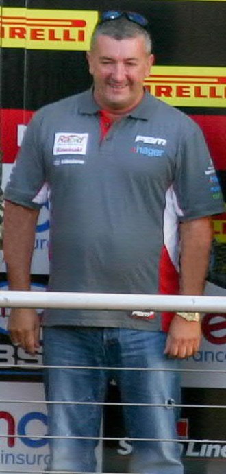 Championship winning team principal, the late Paul Bird acknowledging the spectators' plaudits at Brands Hatch Showdown podium, end of BSB season 2014