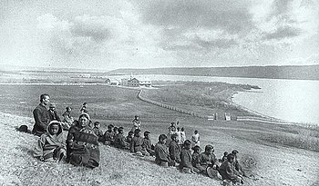 Students and family members, Father Joseph Hugonard (principal), staff and Grey Nuns on a hill overlooking the Qu'Appelle Industrial School, May 1885 Qu'Appelle Industrial School 1885.jpg