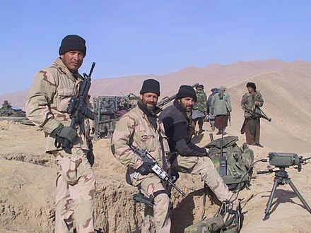 Special Forces soldiers alongside Northern Alliance fighters west of Kunduz, November 2001
