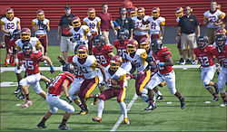 The Schaumburg HS Football team take on Mid-Suburban League rivals Barrington in 2014. Schaumburg Saxons High School Football Team.jpg