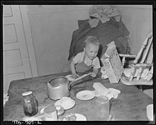 Child playing around the kitchen Son of Charles B. Lewis, miner, playing around kitchen table in home in company housing project. Union Pacific Coal... - NARA - 540564.jpg