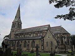 Iglesia de San Bartolomé (1875), Roby, Lancashire, sólidamente construida en piedra facetada como roca con apósitos de sillería. La iglesia tiene un impresionante campanario del oeste con una aguja de broche y tiene un destacado clerestorio y una cancela en ábside.[58]​