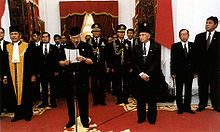 Suharto reads his address of resignation at Merdeka Palace on 21 May 1998. Suharto's VP and successor, B. J. Habibie, was on his left. Suharto resigns.jpg