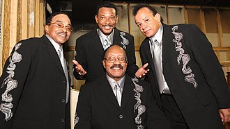 Mark Scott, lead singer, with The Miracles in 2010 The Miracles (2010).jpg