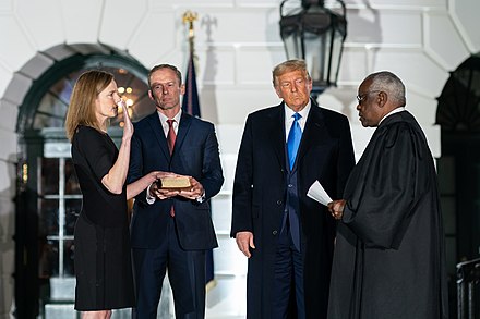 Justice Clarence Thomas administers the oath of office to Barrett on October 26, 2020, at the White House alongside President Donald Trump