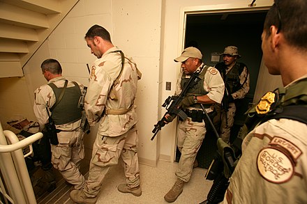 A Border Patrol Special Response Team searches a hotel room-by-room in New Orleans in response to Hurricane Katrina.
