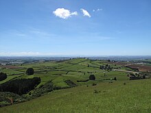 The Bombay Cones are in the center of this view from Mount Puketutu towards the northwest. View looking north-west towards Auckland from top of Mount Puketutu.jpg
