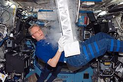 European Space Agency (ESA) astronaut Thomas Reiter, STS-116 mission specialist, works with the Passive Observatories for Experimental Microbial Systems in Micro-G (POEMS) payload in the Minus Eighty Degree Laboratory Freezer for ISS (MELFI) in the Destiny laboratory of the International Space Station while Space Shuttle Discovery was docked with the station. MELFI is a low temperature freezer facility with nominal operating temperatures of −80, −26 and +4 degrees Celsius that will preserve experiment materials over long periods.