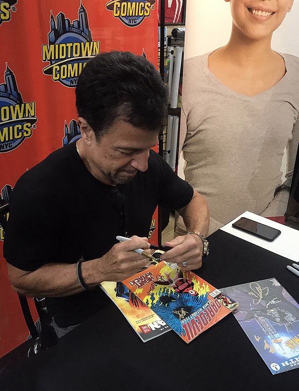 Artist John Romita Jr., signing a copy of issue 254 of the series at Midtown Comics in Manhattan