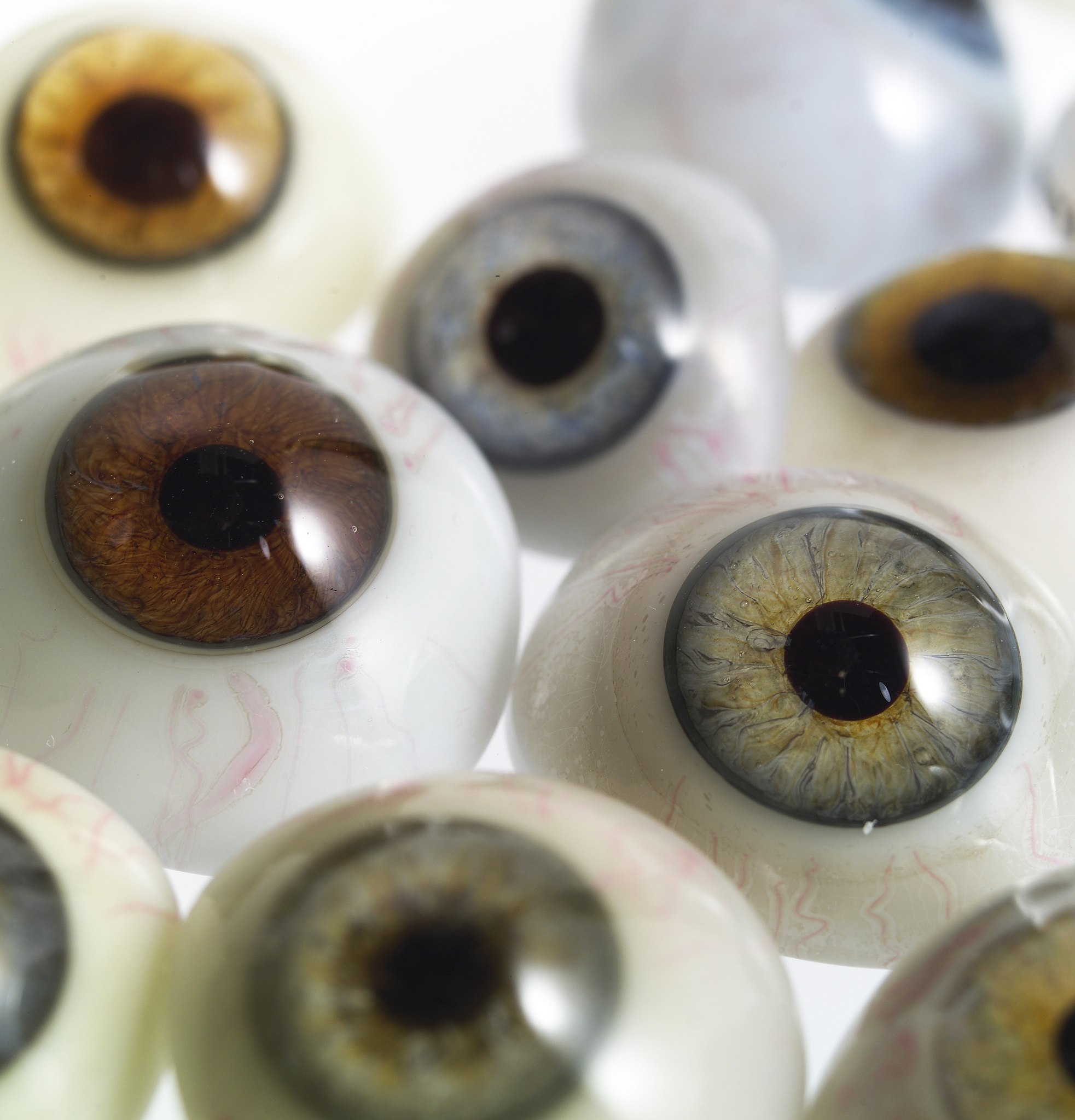 A selection of glass eyes from an opticians glass eye case.