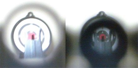 Pictures taken under identical conditions through large (left) and small (right) diameter aperture sights, with camera focused on front sight