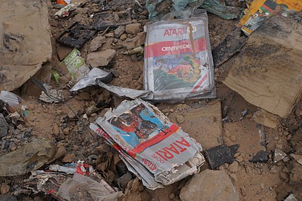 Partially-surviving cases and cartridges retrieved during the 2014 excavation of the Alamogordo, New Mexico landfill Atari had used in 1983. E.T., Centipede, and other Atari materials can be seen.