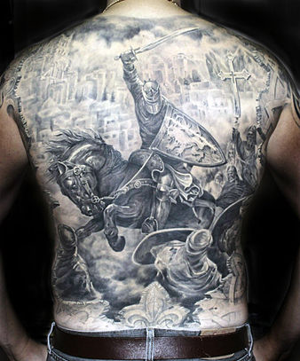 Black-and-gray tattoo illustrating The Crusades that encompasses the entire backside. The shading technique on the shield and other elements is pronounced and creates a sense of depth. Crusade tattoo.jpg