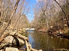 Low dam upriver on Mianus River in Mianus River Park near Old Mill Lane in Stamford, Connecticut.