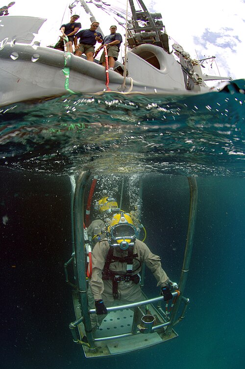 A US Navy work diver is lowered to the sea bed during a dive from the USNS Grasp (T-ARS-51) off the coast of St. Kitts.