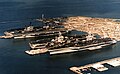 Four US Navy carriers at Norfolk Naval Station 1985.jpeg
