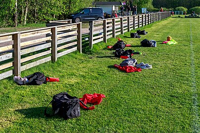 Gear by the fence at the soccer training field in Brastad