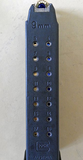A Glock 9×19mm Parabellum 17-round magazine. The numbered witness holes at the back portion visually indicate how many cartridges are contained in the magazine.