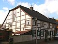 Eaves half-timbered house with a crooked hip