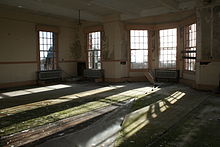 A day room typical of the hospital, with large bay windows to let as much sunlight in as possible Hellingly day room.JPG