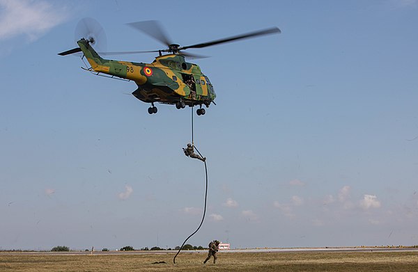 An IAR 330 of the 572nd Helicopter Squadron unloads troops of the 502nd Infantry Regiment, 101st Airborne by fast rope