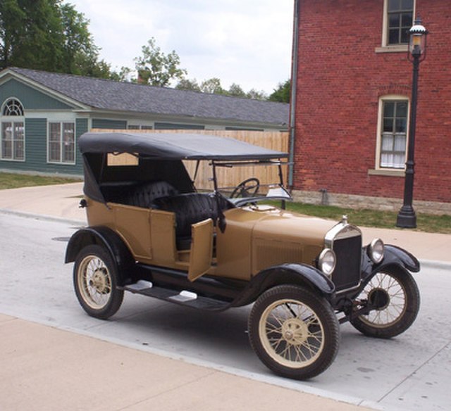 Tourists can ride in a Model T in Greenfield Village at The Henry Ford, a National Historic Landmark.