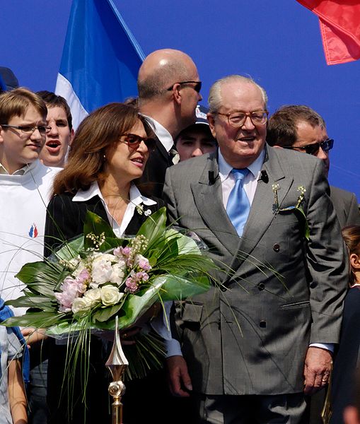 "Jany" Paschos, his second wife, with Le Pen at his National Front party's annual march to the statue of Joan of Arc, Place des Pyramides, Paris, May 