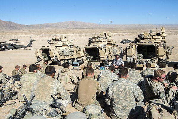 Mark Esper talks with Soldiers of the 1st Armored Brigade Combat Team, 1st Cavalry Division, during their rotation to the National Training Center. (U