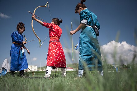 Young Mongolian women prepare for an archery shoot