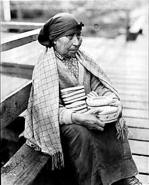 A Nuu-chah-nulth woman selling baskets in Nootka Sound in the 1930s